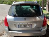 a silver car that is parked on the side of the road