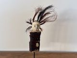 a small vase with a bird in it on a table