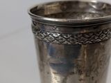 a silver cup that is sitting on a table