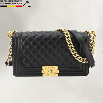 a black chanel bag with a gold chain strap