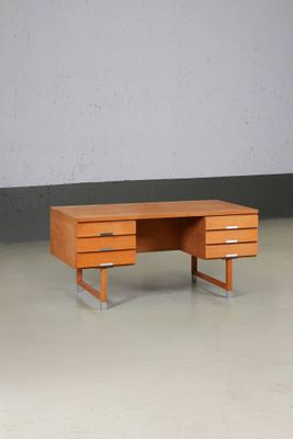 a wooden desk with two drawers in a room