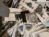 a pile of old photographs on the floor