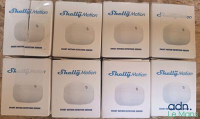 six boxes of small white electronic devices sitting on top of a table