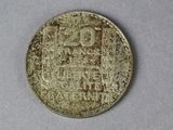 a close up of a coin on a table with a white background