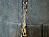 a close up of a zipper on a black jacket