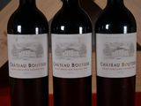 three bottles of wine sitting next to each other on a table
