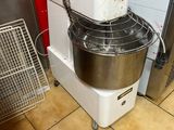 an image of a mixer in a kitchen with a red wall