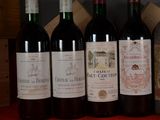 several bottles of wine are lined up on a table