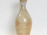 a small vase that is sitting on a white surface