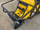 a small yellow motorcycle parked in a parking lot