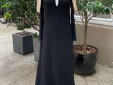 a mannequin on a mannequin stand in front of a building