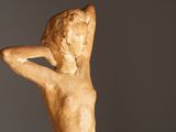 statue of a woman with her hands behind her head
