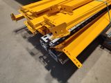 several pieces of yellow construction equipment are stacked on top of each other