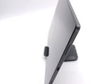 a laptop that is sitting on a stand on a table