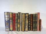 many old books lined up on a white surface