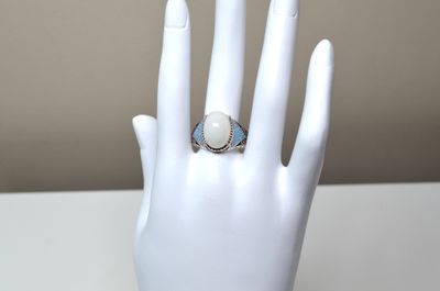 an image of a woman ' s hand with a ring on it