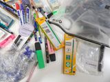 a lot of pens and pencils on the table
