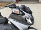 a motor scooter parked in front of a garage