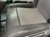 a picture of a dirty car seat in the back of a truck