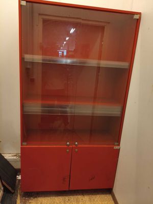 an image of a red bookcase with glass doors
