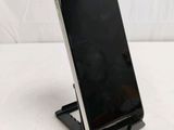 a cell phone that is on a stand on a table