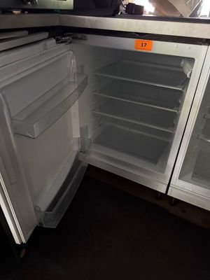 an open refrigerator with its door open in a kitchen