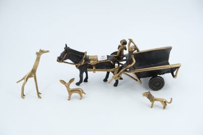 a figurine of a horse pulling a carriage with people and dogs