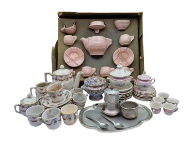 a lot of pink and white dishes and cups in a box