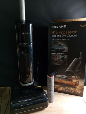 a vacuum that is sitting on a table next to a book