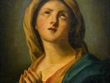 un tableau représentant une femme en train de prier, les mains jointes