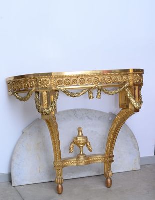 a gold table with a statue on top of it