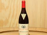 une bouteille de vin posée sur un tonneau