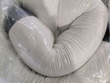 a white pillow that is wrapped in plastic