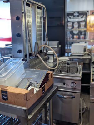 une cuisine équipée de nombreux appareils électroménagers et offrant un grand plan de travail