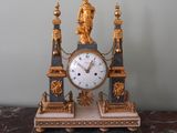 a clock that is sitting on top of a marble table