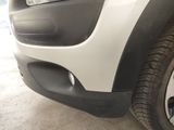 a close up view of a car ' s front bumper and tire