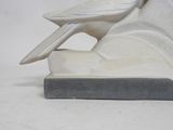 statue of a bird on a rock with a white background