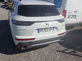 the rear end of a white suv parked in a parking lot