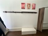 an image of a closet with clothes hanging on a rail