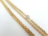 a close up of a gold chain on a white background