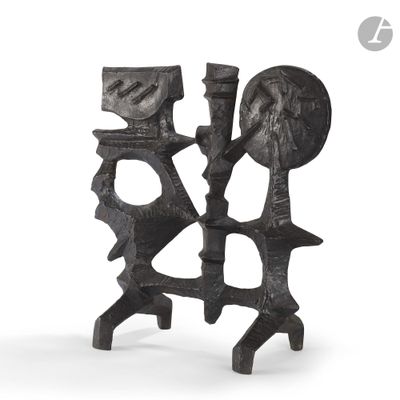 pair of black iron candlesticks with faces on them on a white background