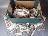 a box full of old photos of people and buildings