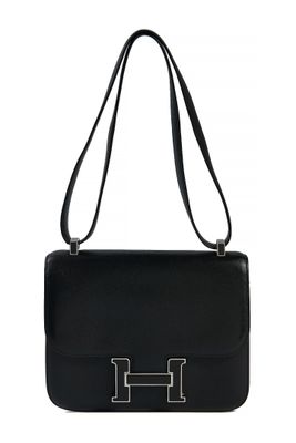 a black leather handbag with a metal handle