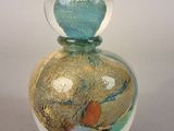 a small glass vase with a sand inside of it