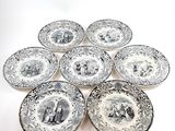 six plates with black and white designs on them on a white surface
