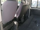 two seats in the back of a van that is empty