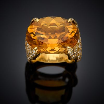 an orange sapphire and diamond ring