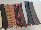 many different ties laid out on a white surface