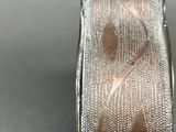 a close up of a silver vase with a design on it
