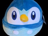 a blue and white penguin hat with a yellow beak